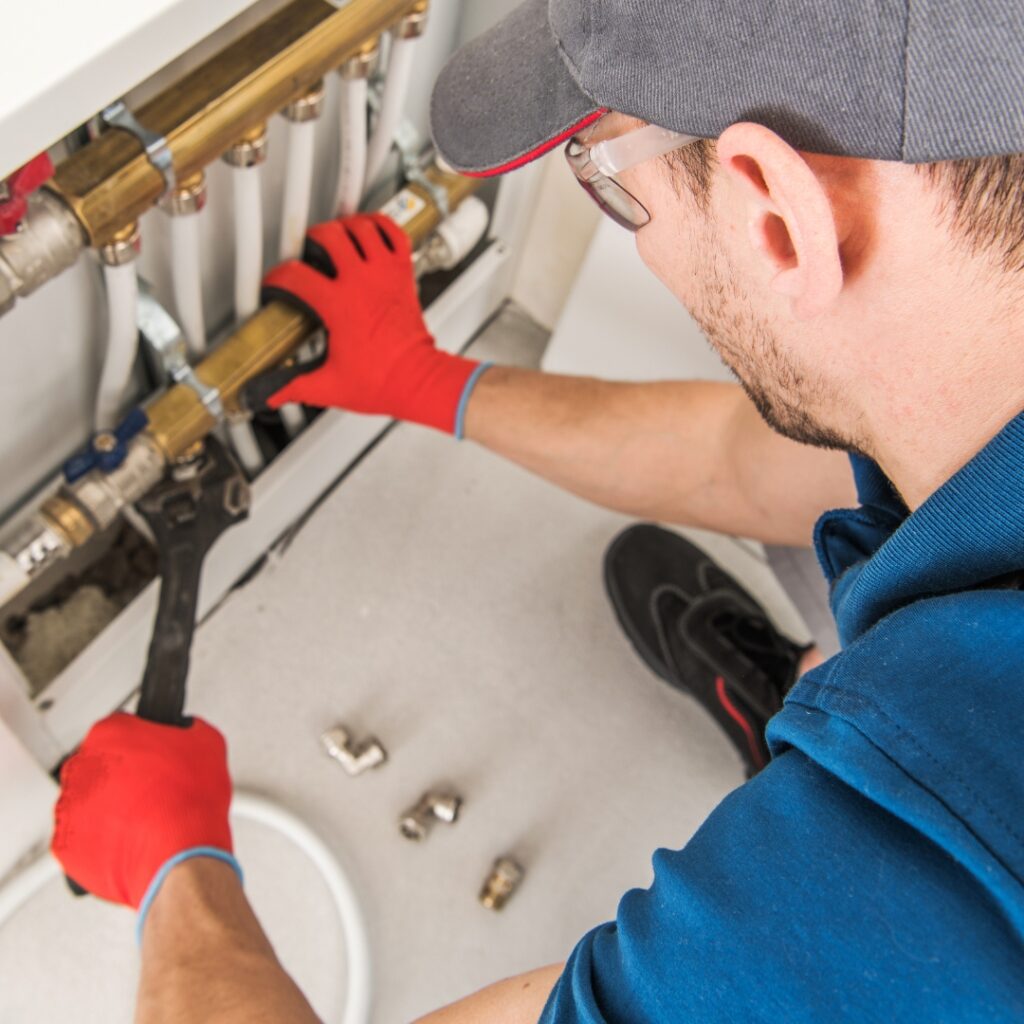 plumber working on pipes