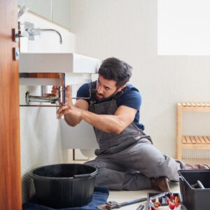 plumber fixing sink drain